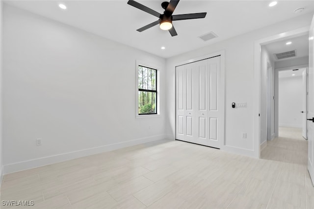 unfurnished bedroom featuring ceiling fan and a closet