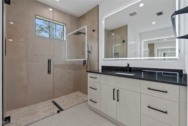 bathroom featuring tile patterned floors, vanity, and an enclosed shower