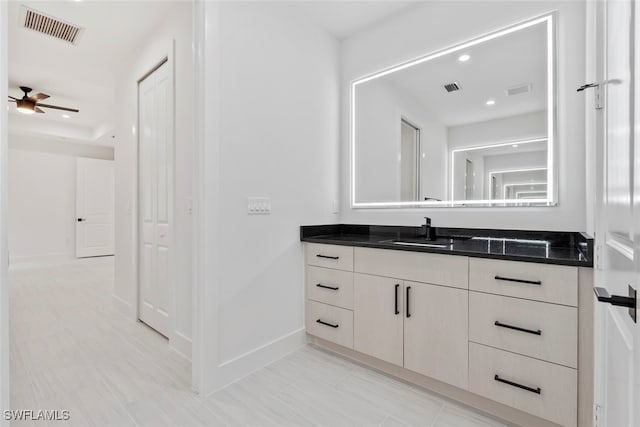 bathroom featuring ceiling fan and vanity