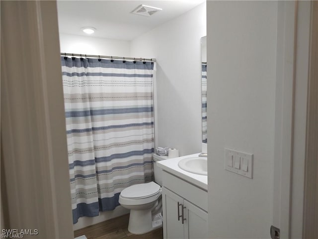 bathroom featuring a shower with curtain, vanity, wood-type flooring, and toilet