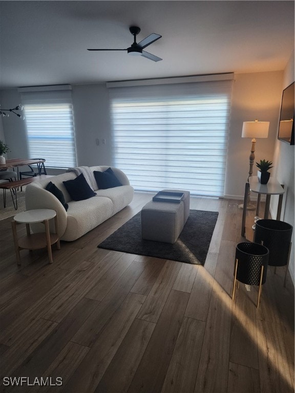 living room with wood-type flooring and ceiling fan