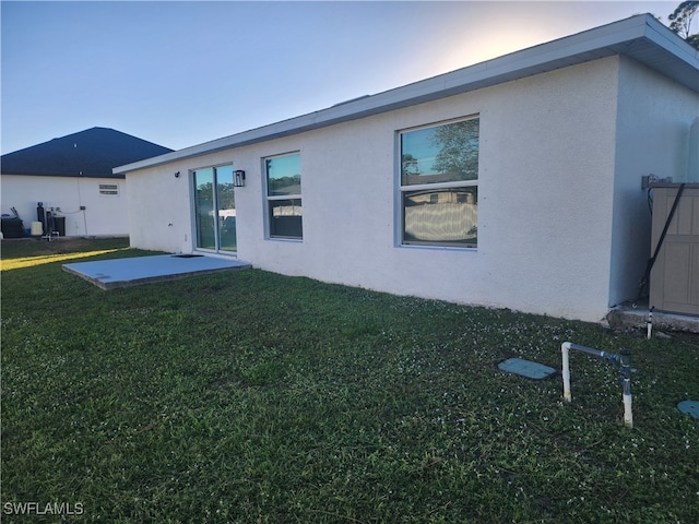 rear view of house with a yard and a patio