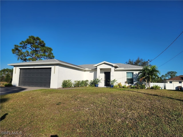 view of front of property with a garage and a front lawn