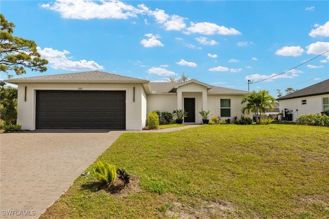 prairie-style home featuring a garage, stucco siding, decorative driveway, and a front yard