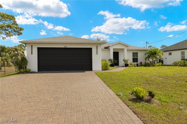 view of front facade featuring a garage, a front yard, decorative driveway, and stucco siding