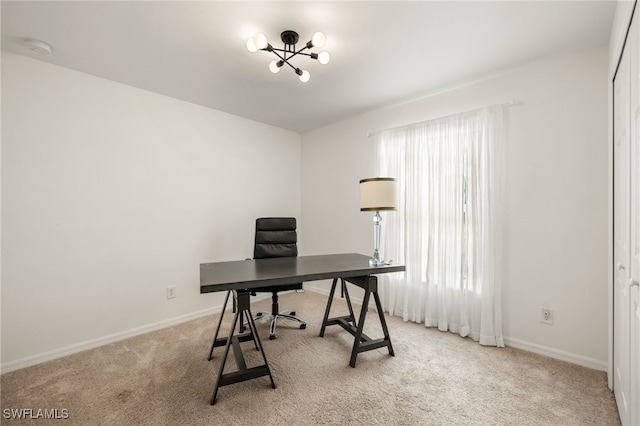 office space featuring carpet floors, an inviting chandelier, and baseboards