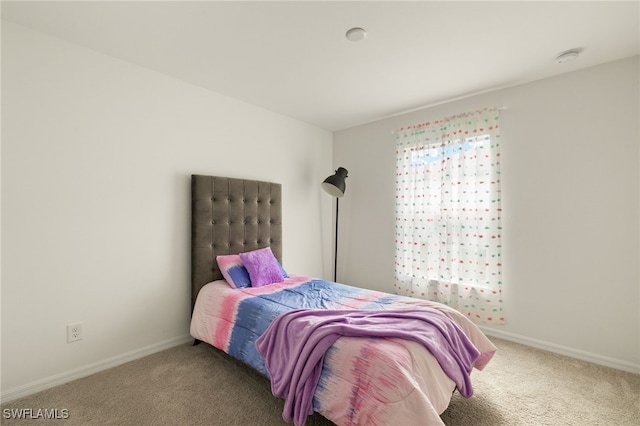 carpeted bedroom with baseboards