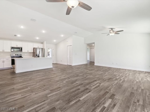 unfurnished living room featuring ceiling fan, lofted ceiling, and dark wood-type flooring