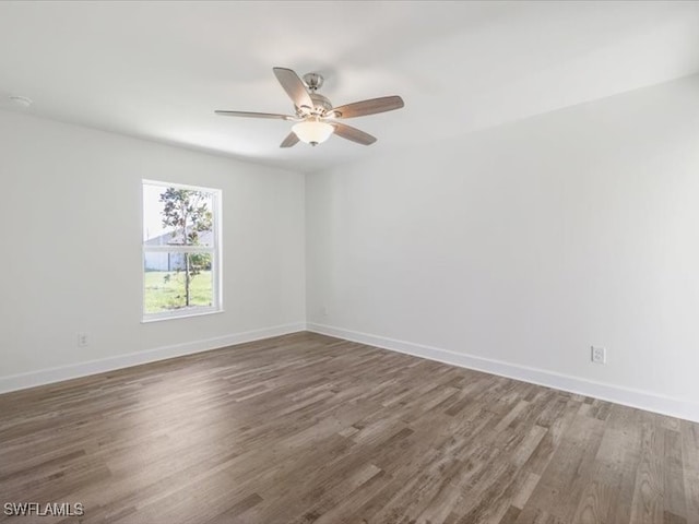 empty room featuring ceiling fan and dark wood-type flooring