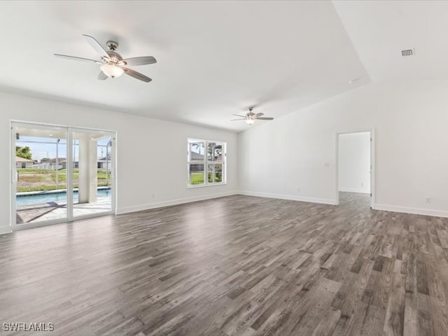 unfurnished living room featuring dark hardwood / wood-style floors, ceiling fan, and lofted ceiling