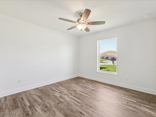 spare room with hardwood / wood-style floors and ceiling fan