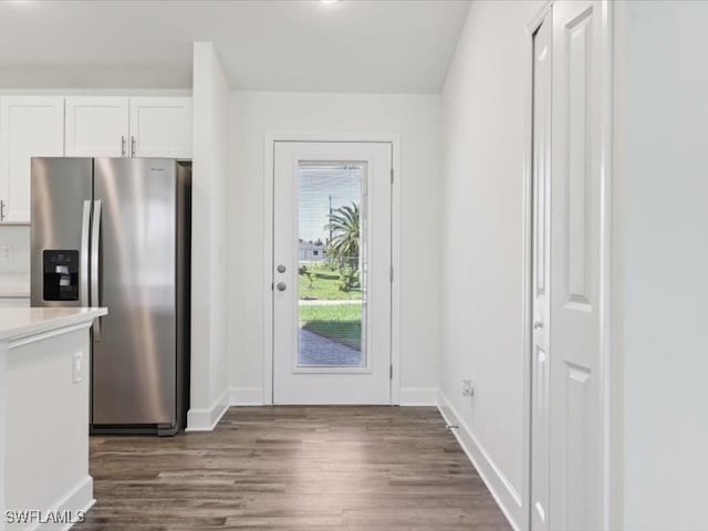 kitchen featuring stainless steel fridge with ice dispenser, dark hardwood / wood-style floors, and white cabinetry