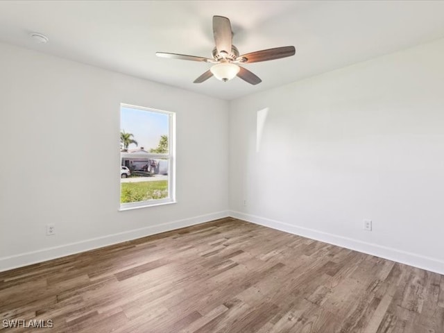 empty room featuring wood-type flooring and ceiling fan