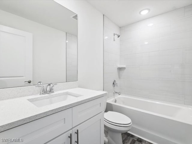 full bathroom with wood-type flooring, vanity, toilet, and tiled shower / bath