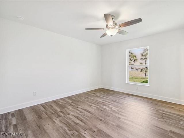 empty room featuring hardwood / wood-style floors and ceiling fan