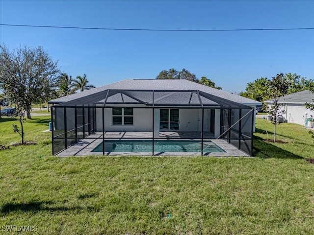 back of house with a lawn, glass enclosure, and a patio area