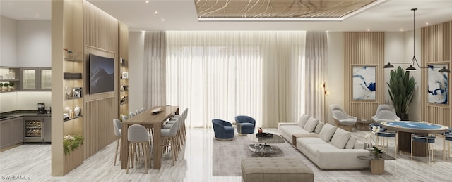 living room featuring wine cooler, plenty of natural light, and light hardwood / wood-style flooring