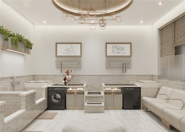 kitchen with washer / dryer, light hardwood / wood-style flooring, and a raised ceiling