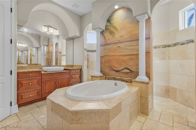 bathroom featuring vanity, ornate columns, and independent shower and bath