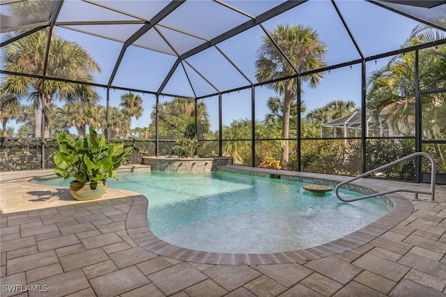 view of pool featuring pool water feature, a lanai, and a patio