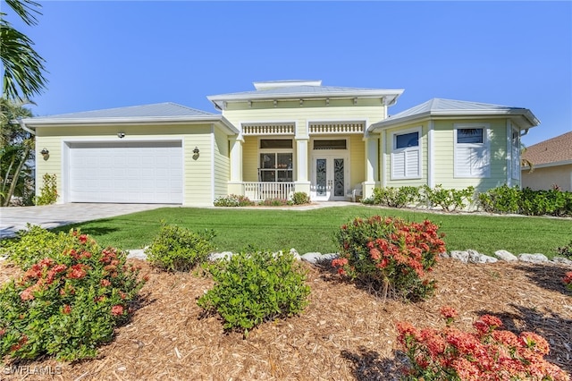 view of front of home with a porch, a garage, a front yard, and french doors