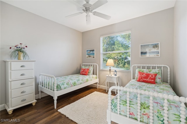 bedroom with ceiling fan and dark hardwood / wood-style floors