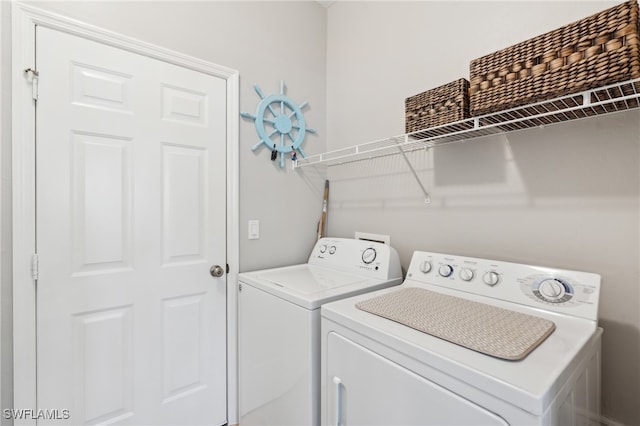 laundry area featuring washing machine and clothes dryer