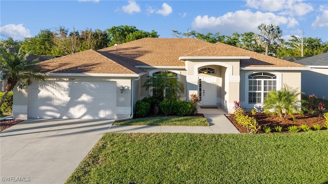 ranch-style home with a front lawn and a garage