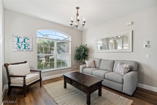 living room featuring a chandelier, dark hardwood / wood-style floors, and plenty of natural light