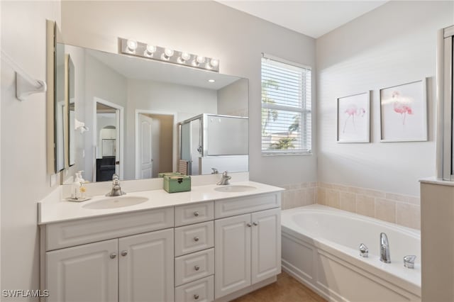 bathroom featuring vanity and shower with separate bathtub