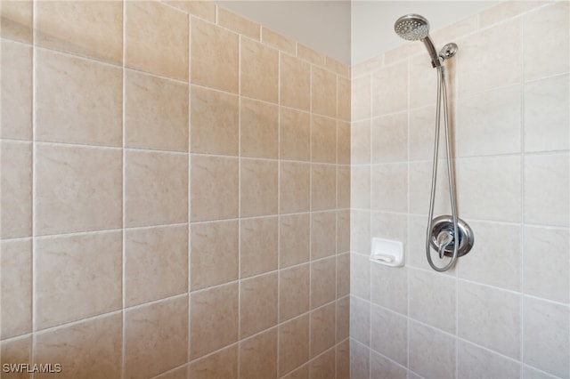 bathroom with tiled shower