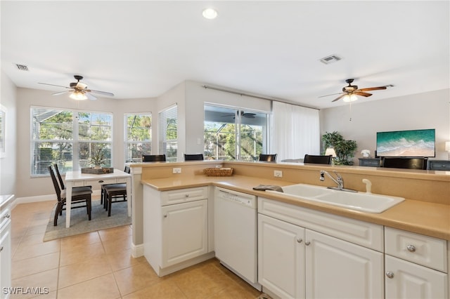 kitchen featuring white dishwasher, ceiling fan, sink, light tile patterned floors, and white cabinetry