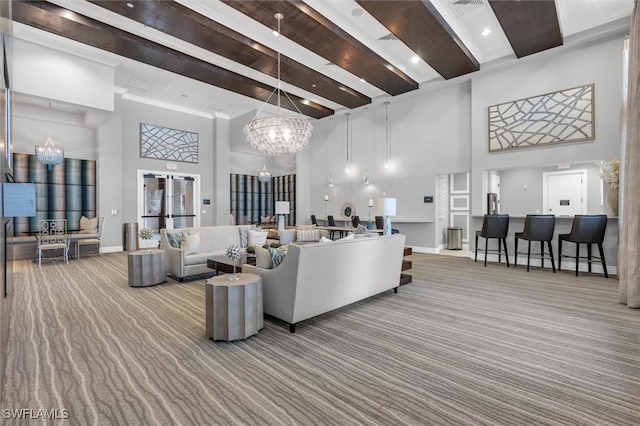 carpeted living room with beam ceiling, a towering ceiling, and an inviting chandelier