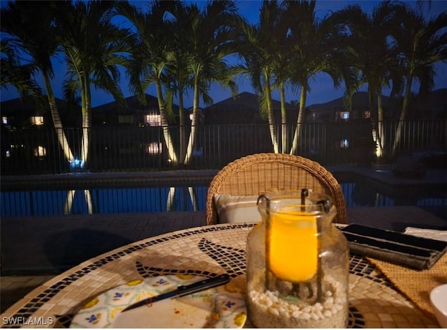 pool at twilight featuring a patio area