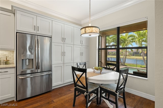 dining room with ornamental molding and dark wood-type flooring