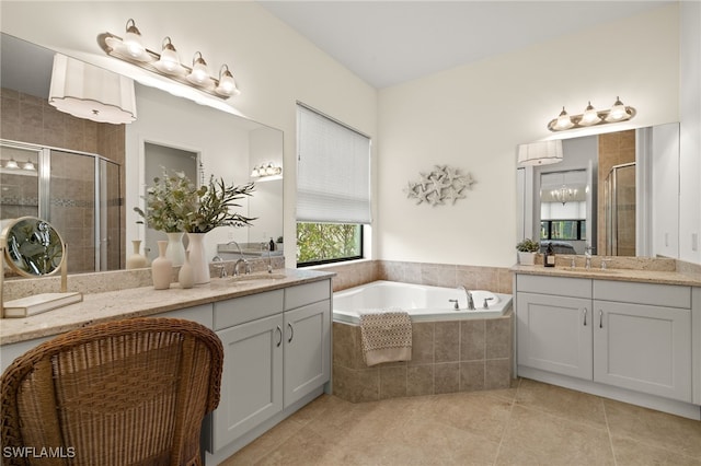 bathroom with tile patterned floors, vanity, and independent shower and bath