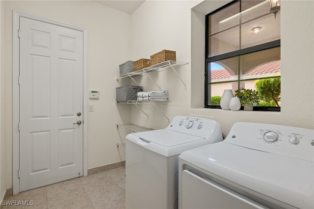 clothes washing area featuring washer and dryer