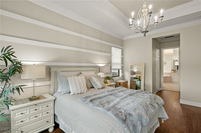 bedroom featuring a notable chandelier, dark hardwood / wood-style floors, crown molding, and ensuite bath