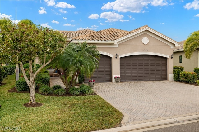 mediterranean / spanish-style house with a front lawn and a garage