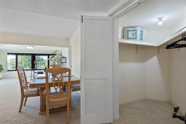 dining area featuring light carpet