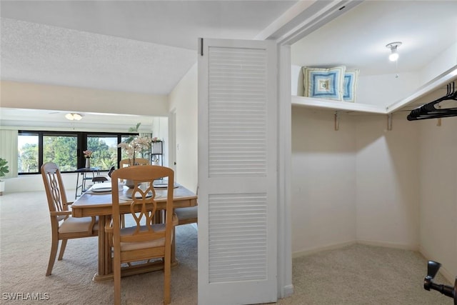 dining space featuring carpet flooring and baseboards