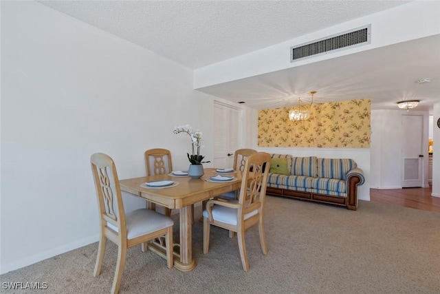 dining space featuring a notable chandelier, a wainscoted wall, visible vents, and carpet floors