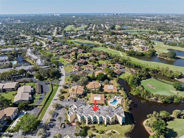 drone / aerial view featuring a water view, a residential view, and view of golf course