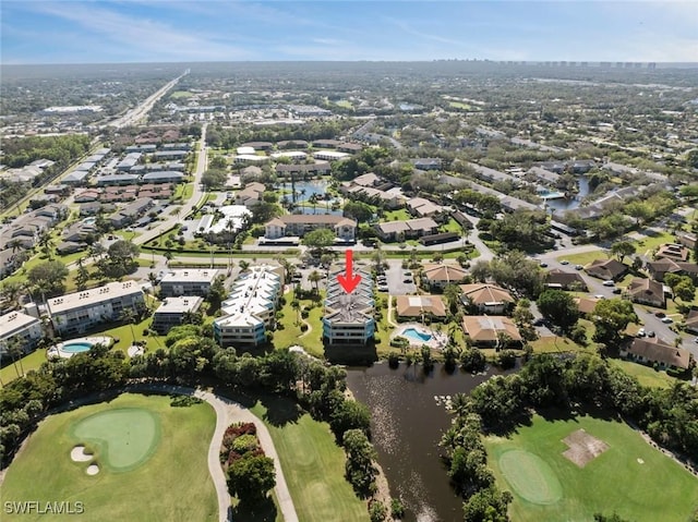 birds eye view of property featuring view of golf course, a water view, and a residential view