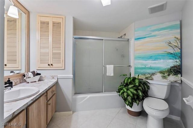 full bathroom with toilet, combined bath / shower with glass door, tile patterned floors, visible vents, and vanity