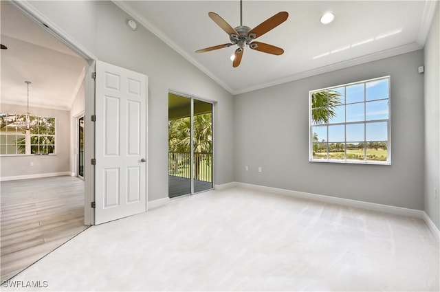 unfurnished room with lofted ceiling, crown molding, and a wealth of natural light