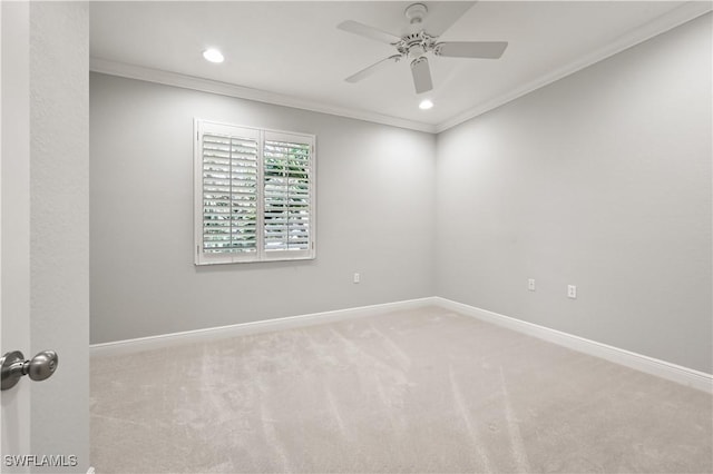 spare room featuring crown molding, carpet floors, and ceiling fan