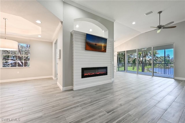 unfurnished living room featuring ceiling fan, light hardwood / wood-style floors, and ornamental molding