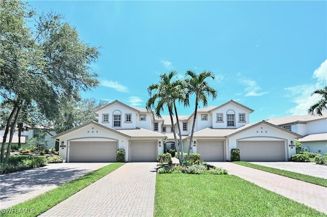 view of front facade with a front yard and a garage