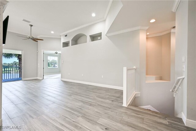 unfurnished living room with ceiling fan, light hardwood / wood-style floors, and crown molding